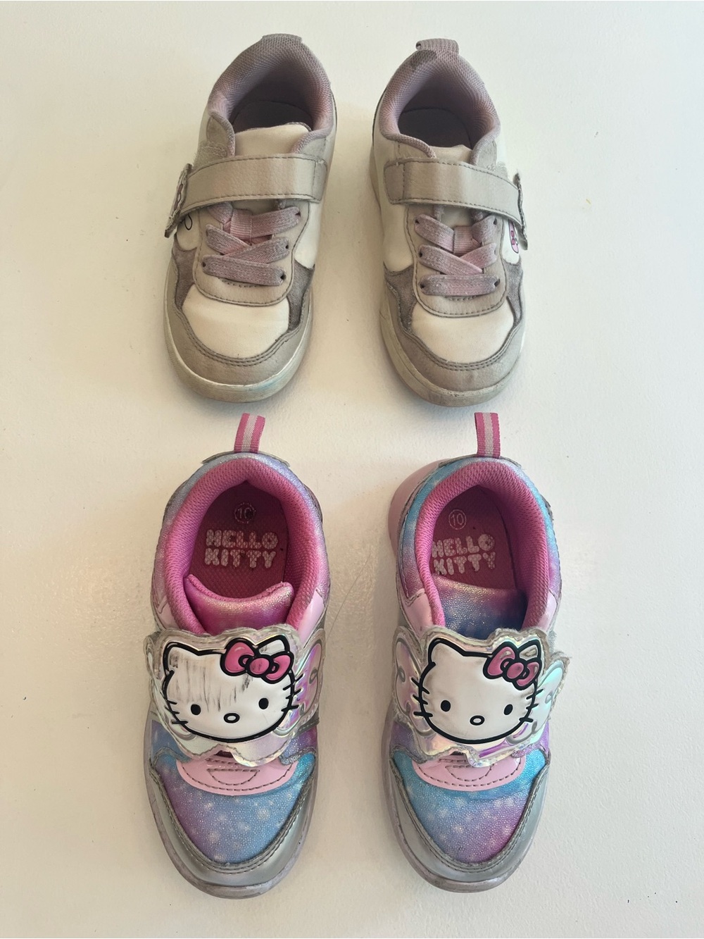 2 pairs of hello kitty runners. Size 10. One lights up.